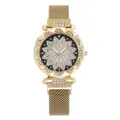 Detailed macro view of gold-tone floral dial with sparkling rhinestones on mesh watch band - Gold