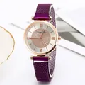 Detail of starry dial watch with purple mesh strap and rose gold bezel in macro view - Purple
