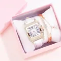 Close-up of gold square diamond watch with white leather strap in pink gift box - White Watch And Bracelet And Box
