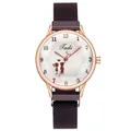 Detailed macro view of the rose gold mesh band and quartz watch face with heart pattern - Purple