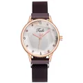 Close-up of ladies quartz watch featuring a purple sunray dial and mesh magnetic band - Purple