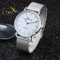 Geneva silver mesh strap quartz watch with minimalist white dial on a dark textured surface - Silver
