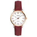 Macro detail of rose gold case and white dial with Roman numerals on a quartz watch - Red