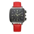 Detail view of the square black dial with gold markers and red leather stitched strap - Red