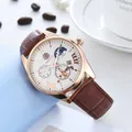 Close-up of mechanical watch with moon phase, Roman numerals, and brown leather strap - Rose Gold Case White Dial Brown Strap