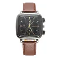 Detail of square silver metal watch case with black dial and brown leather strap - Coffee