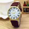 Detail of elegant gold watch with mother-of-pearl dial and burgundy leather strap - Coffee