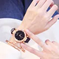 Macro shot of Candycat watch with starry black dial, rose gold bezel, and star charm bracelet - Watch And Bracelet / Black