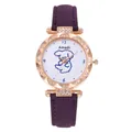 Macro shot of rose gold watch case with rhinestone bezel and purple matte strap - Purple
