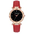 Detailed close-up of the black starry sky dial and rose gold bezel on a women's leather watch - Red