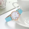 Close-up of minimalist light blue quartz watch with rainbow weather icons on white dial - Sky Blue