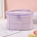 Elegant purple quilted cosmetic bag featuring dual zippers and a portable top handle - Purple