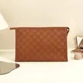 Brown checkerboard PU leather makeup bag with zipper closure on a vanity desk - Mocha Brown