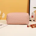 Pink woven PU leather cosmetic bag with a gold zipper and minimalist storage design - Woven Pattern / Pink