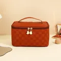 Caramel brown large makeup bag with checkered texture and golden zippers on vanity - Checkerboard Brown