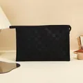 Black checkered makeup bag with side handle and top zipper in an elegant travel setting - Midnight Black