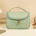 Mint green checkered toiletry bag with premium leather finish and gold zipper detail - Checkered / Cream Green
