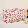 Quilted white floral makeup bag with red flower patterns and gold zipper detail - Red/Floral