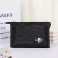 Black mesh makeup bag featuring a cute bear print and zipper closure for travel - Black