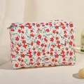 Floral quilted cosmetic bag with red flower prints and white zipper closure - Red Floral