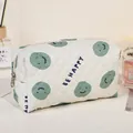 Quilted cream cosmetic bag with green smile pattern and Be Happy text variant - Green/Smiley