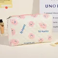 Quilted cream cosmetic bag featuring pink smiley face print and BE HAPPY text detail - Medium / Pink/Smiley