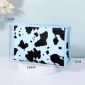 Light blue cow print cosmetic bag with silver zipper and dimensions 24x15x7cm - Briefcase Style