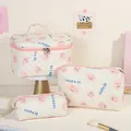 Lot de 3 trousses à maquillage matelassées avec motifs smiley roses et lettrage - Visage Rose/souriant