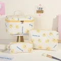 Lot de trois trousses de toilette matelassées avec motif smiley jaune et texte BE HAPPY - Visage Jaune/souriant
