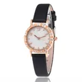 Close-up of rose gold watch case with star motifs and crystals on a black leather strap - Black