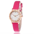 Detailed close-up of rose gold watch case with rhinestone bezel and pink leather strap - Rose Red