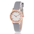 Women's rose gold quartz watch with rhinestones, star bezel and grey leather strap - Gray