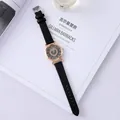 Detail of rose gold watch case with a diamond-encrusted heart pattern on a black dial - Black