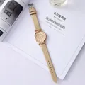 Elegant champagne gold quartz watch with a diamond heart dial on a lifestyle magazine background - Khaki