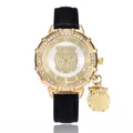 Detailed view of women's gold owl watch with rhinestone bezel and black leather strap - Black