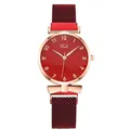 Detailed macro of red sunray dial watch with rose gold case and magnetic mesh band - Red Watch Only