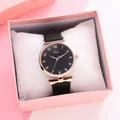 Close-up of Tadi leather watch with rose gold bow charm in a pink gift box - Black With Box