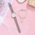 Close-up of a women's quartz watch with grey leather strap and floral charm bracelet - Grey Watch + Bracelet
