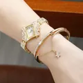 Close-up of gold square dial watch and matching star charm bracelet with rhinestones - Gold Watch and Bracelet Set