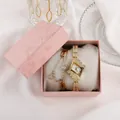 Women's gold diamond quartz watch and star bracelet set in pink gift box on white fabric - Gold Watch and Bracelet Gift Box Set