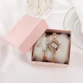 Close-up of diamond-set quartz watch and star charm bracelet in a pink gift box - Rose Gold White Dial And Bracelet And Box
