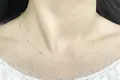 Elegant S925 sterling silver cross chain with cylindrical bead accents on model's neck - Silver