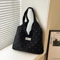 Black canvas tote bag with white floral pattern and Creative Cat label on front - Black