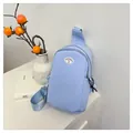 Light blue nylon chest bag with smile patch and adjustable strap in minimalist style - Blue