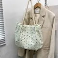 Creamy white textured tote bag with black bow embroidery and thick cotton rope handles - Green