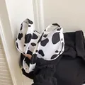 Chic underarm bag featuring trendy cow print pattern and stylish half-moon shape - Cow Print Style