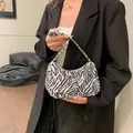 Fashionable black and white zebra print hobo bag with sleek shoulder strap - Zebra Print