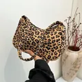 Fashionable leopard print underarm bag with a curved silhouette and golden metal zipper - Brown Leopard Style