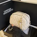 Creamy white quilted crossbody bag with golden chain and double zipper closure design - White
