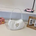White crescent moon handbag with gold heart diamond buckle and sleek zip closure - White
